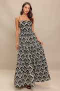 A printed black & ivory woven maxi dress featuring sweetheart neckline, straps, tiered skirt and smocked back bodice