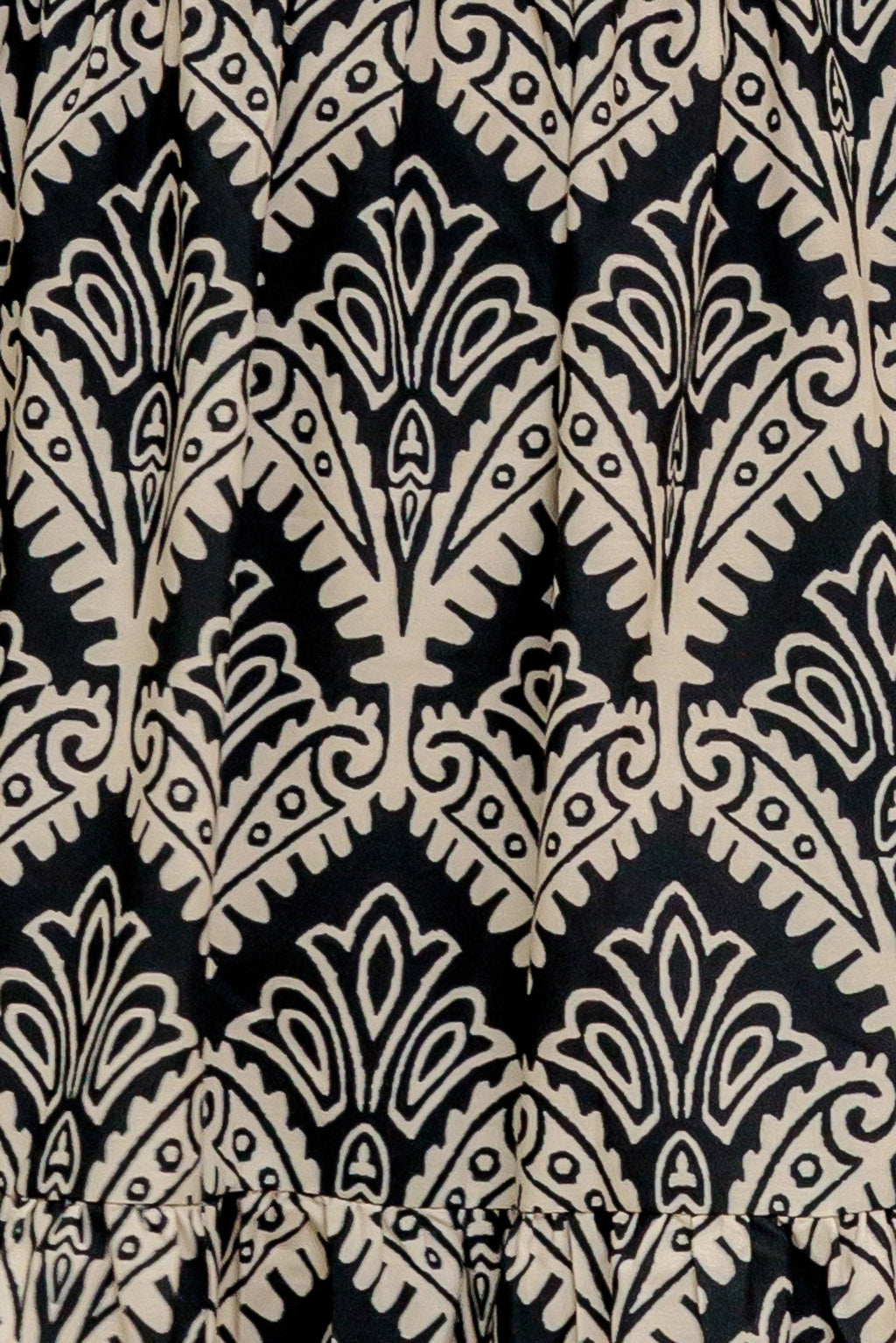 A printed black & ivory woven maxi dress featuring sweetheart neckline, straps, tiered skirt and smocked back bodice