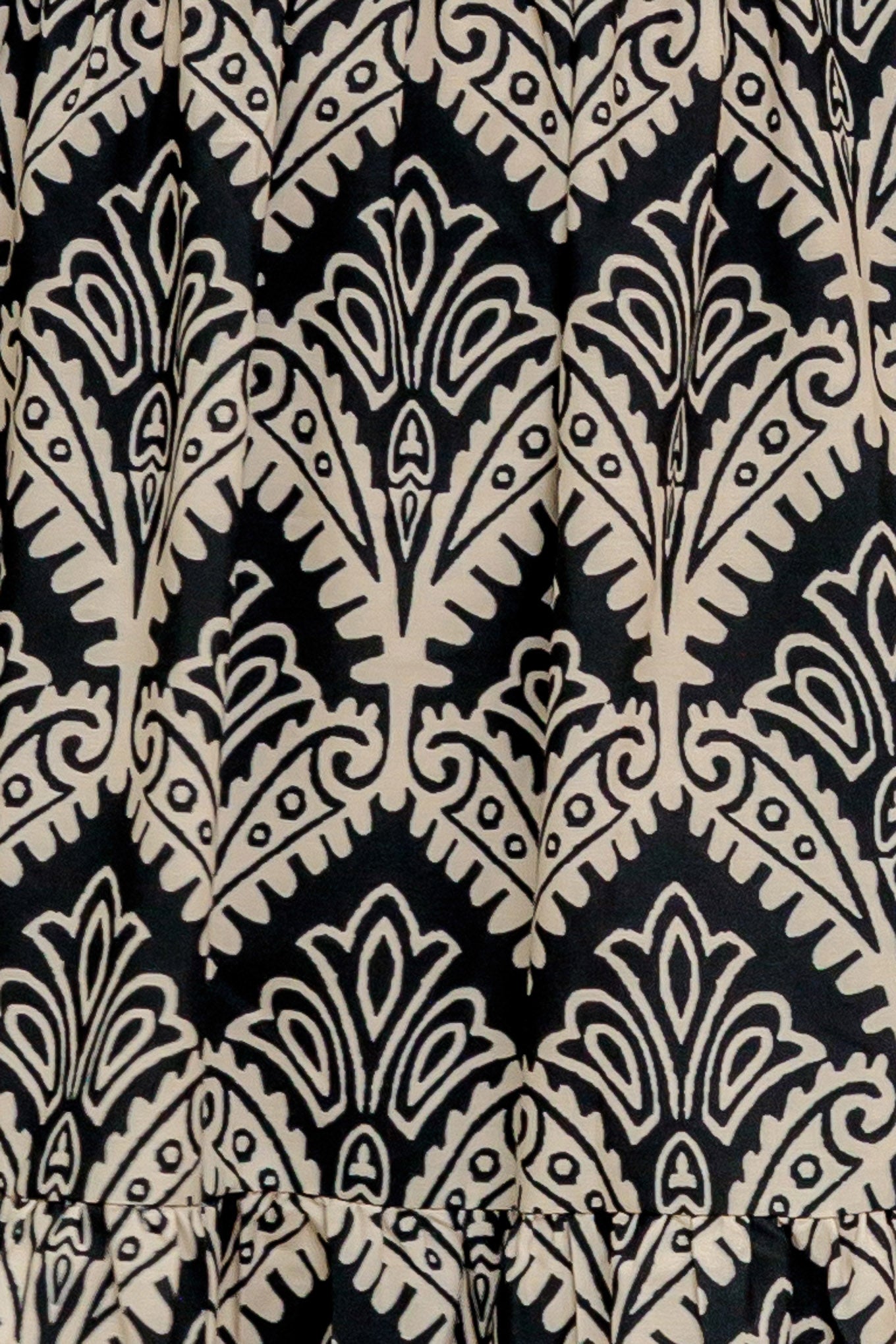 A printed black & ivory woven maxi dress featuring sweetheart neckline, straps, tiered skirt and smocked back bodice