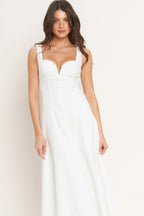 A solid white woven midi dress featuring sweetheart neckline, sleeveless, circle skirt and back zipper closure.