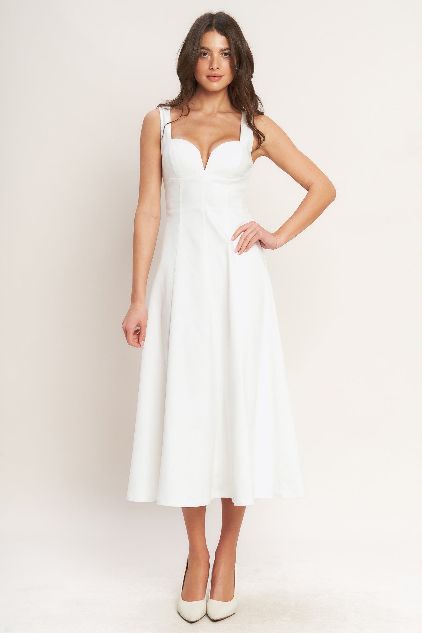 A solid white woven midi dress featuring sweetheart neckline, sleeveless, circle skirt and back zipper closure.