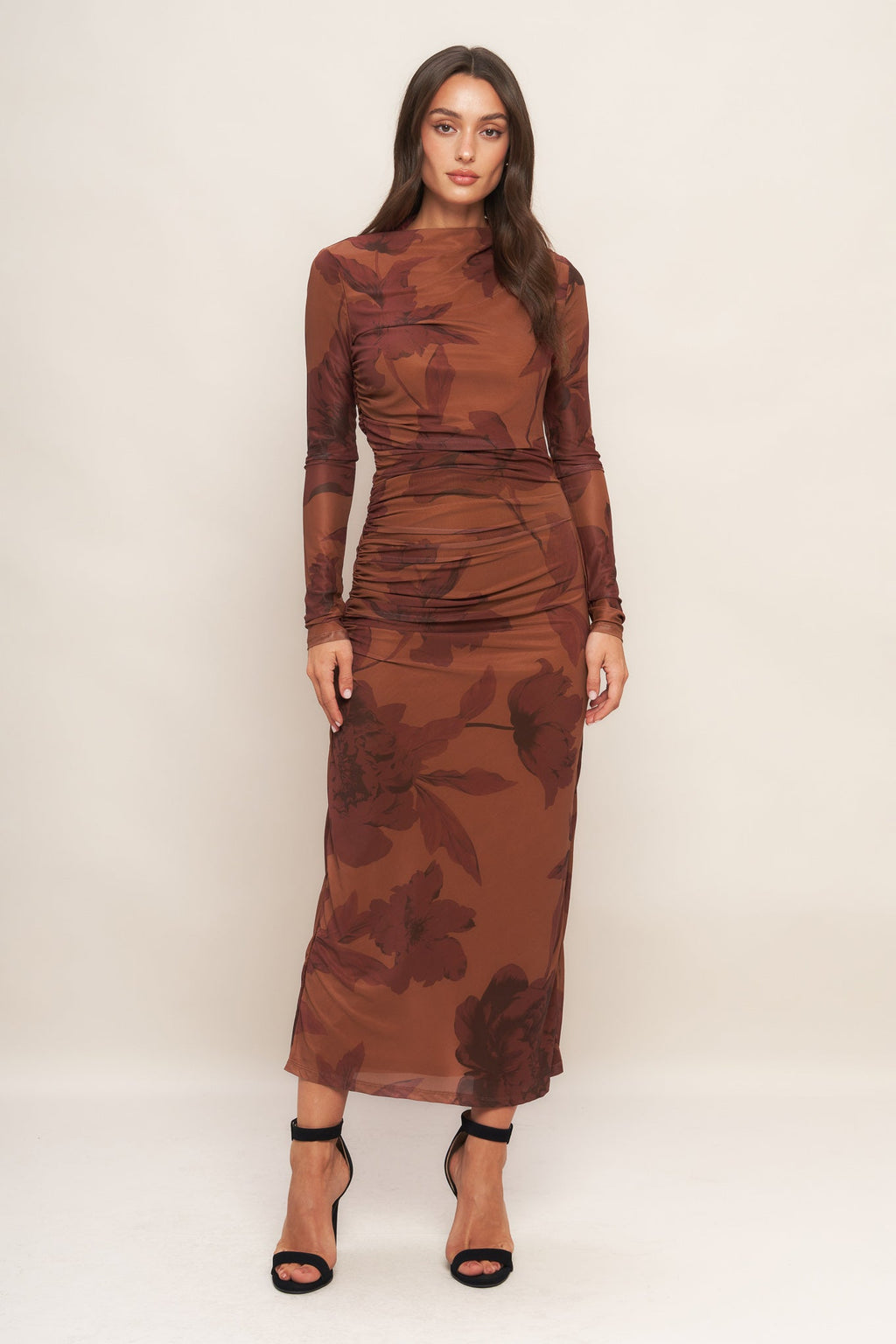 A printed power mesh midi dress featuring long sleeve, side shirring and back zipper closure