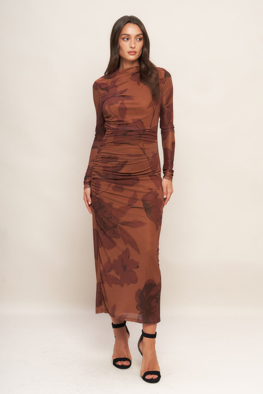 A printed power mesh midi dress featuring long sleeve, side shirring and back zipper closure