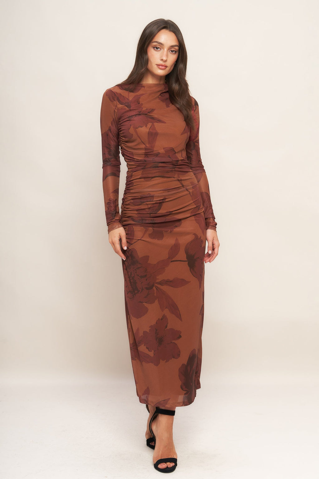 A printed power mesh midi dress featuring long sleeve, side shirring and back zipper closure