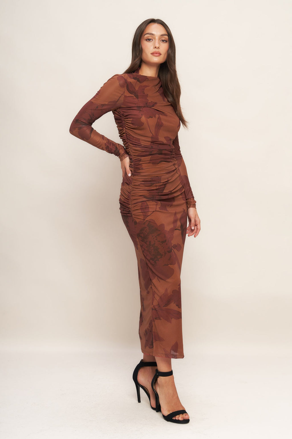 A printed power mesh midi dress featuring long sleeve, side shirring and back zipper closure
