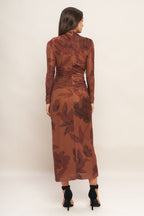 A printed power mesh midi dress featuring long sleeve, side shirring and back zipper closure