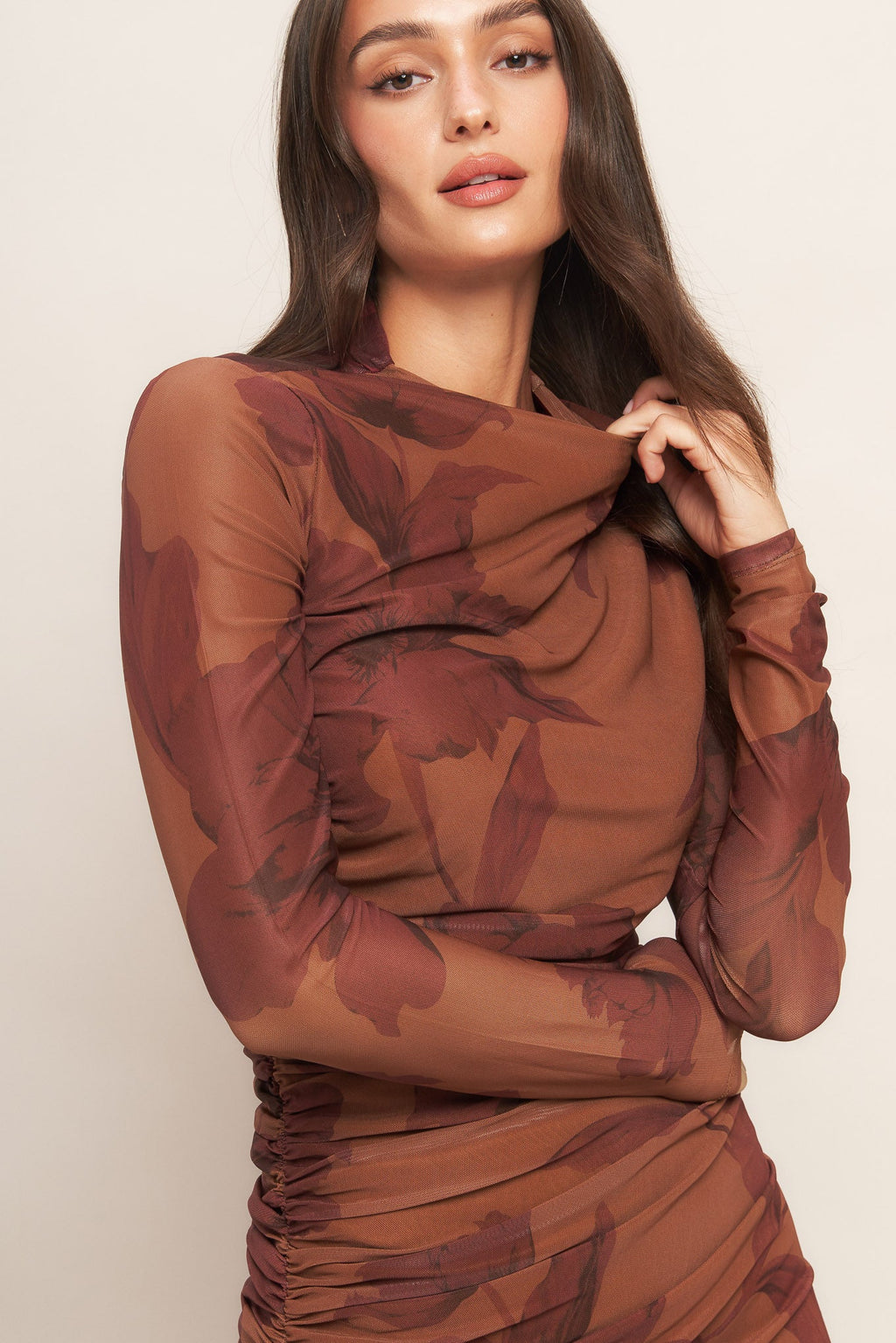 A printed power mesh midi dress featuring long sleeve, side shirring and back zipper closure