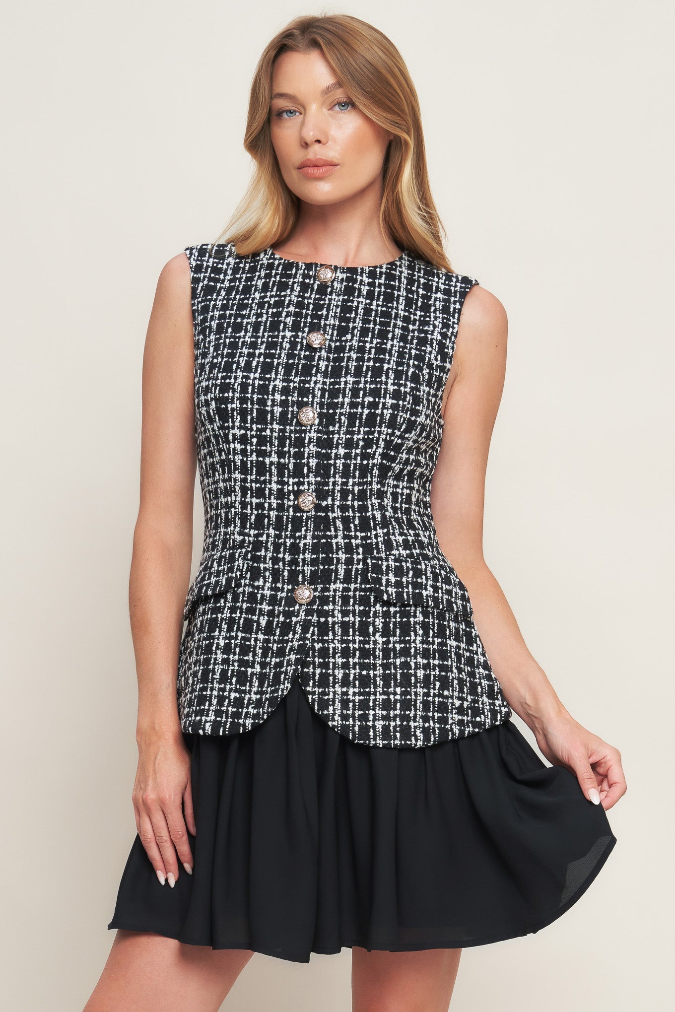 A tweed and solid woven mini dress featuring round neckline, sleeveless, front button down and flowy solid skirt.