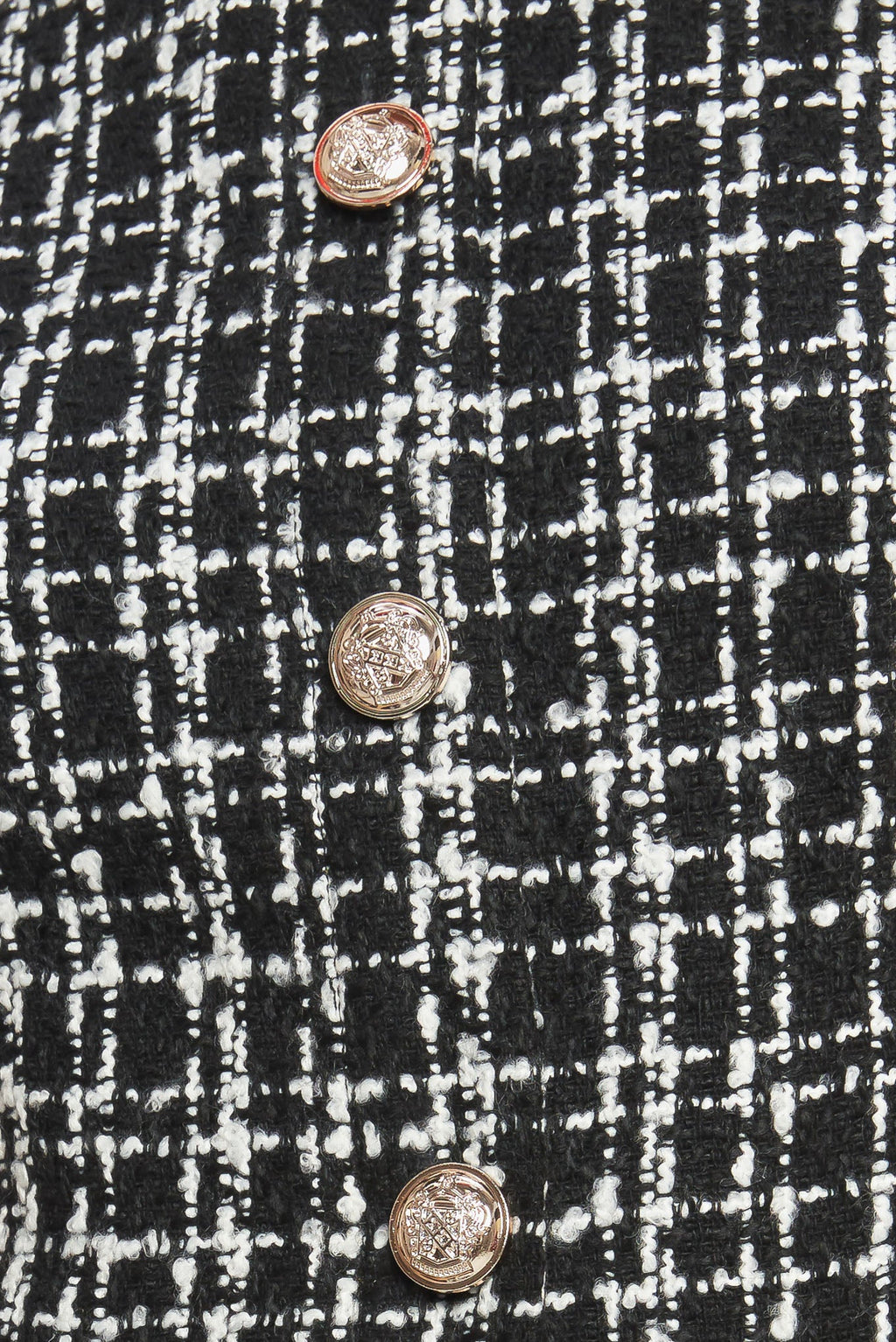 A tweed and solid woven mini dress featuring round neckline, sleeveless, front button down and flowy solid skirt.