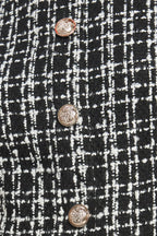 A tweed and solid woven mini dress featuring round neckline, sleeveless, front button down and flowy solid skirt.