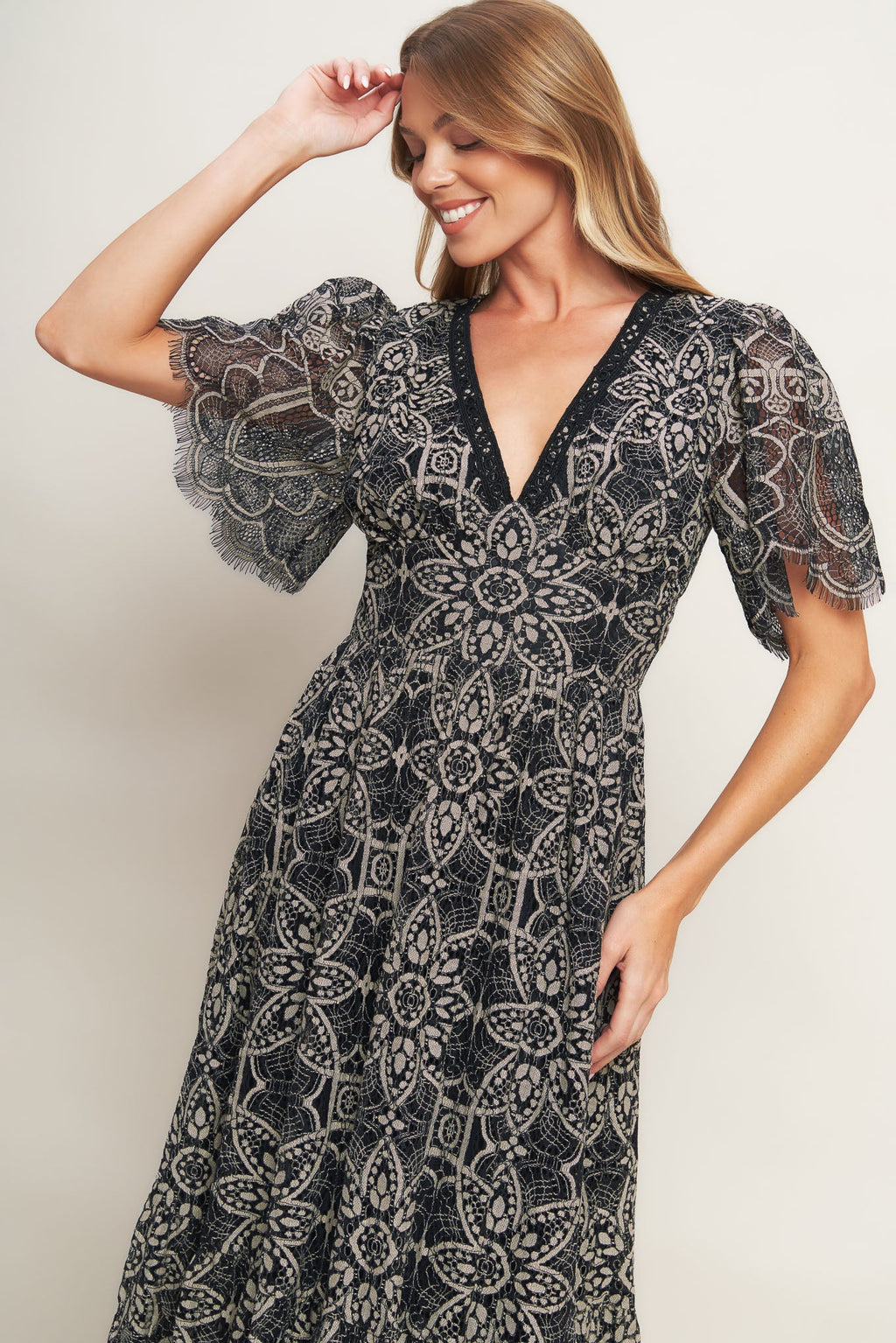 A woven lace midi dress featuring V neckline with lace trim, short sleeve, waist yoke and back zipper closure.