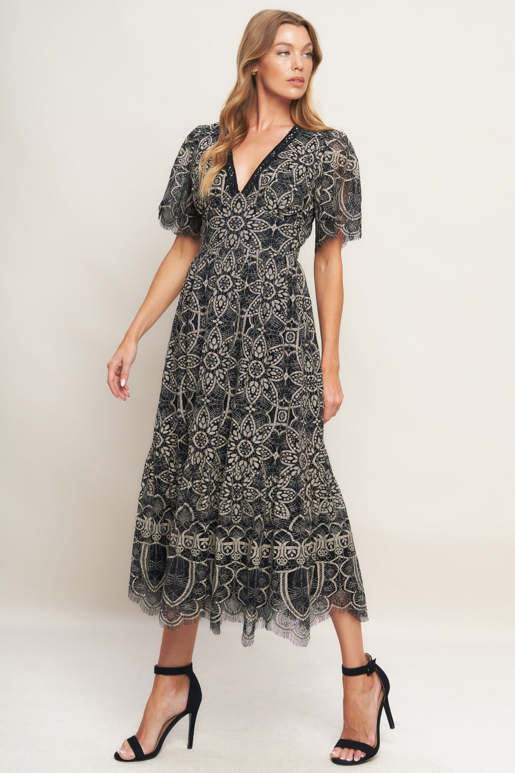 A woven lace midi dress featuring V neckline with lace trim, short sleeve, waist yoke and back zipper closure.
