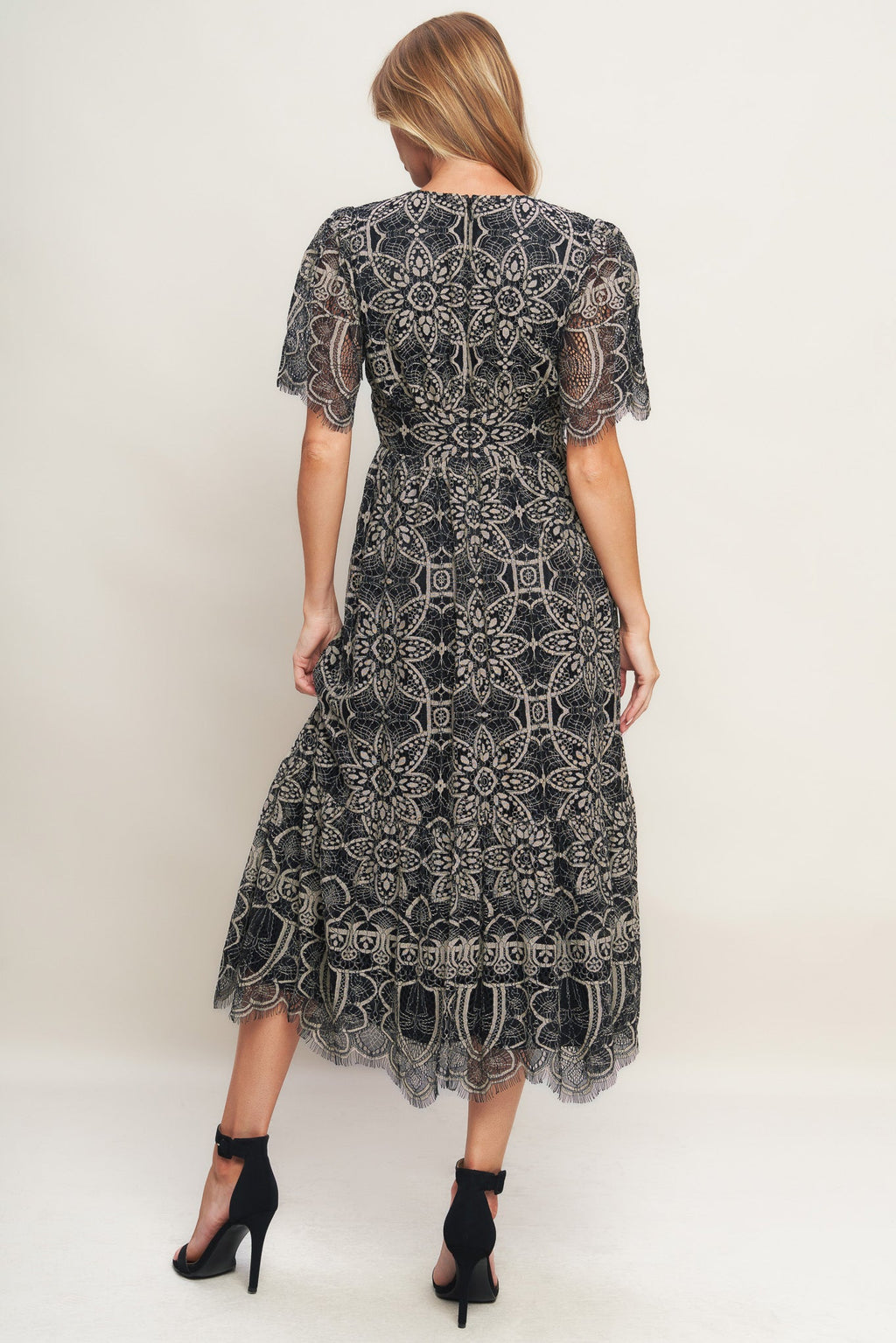 A woven lace midi dress featuring V neckline with lace trim, short sleeve, waist yoke and back zipper closure.