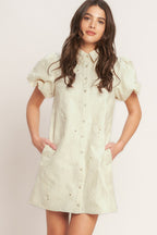 A floral textured woven mini dress featuring collar, short puff short and front button-down closure