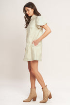 A floral textured woven mini dress featuring collar, short puff short and front button-down closure