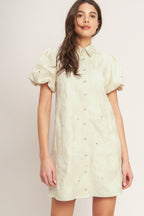A floral textured woven mini dress featuring collar, short puff short and front button-down closure