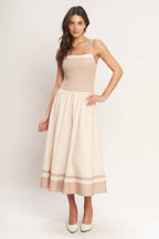 Color blocked midi dress with straight neckline, drop waist, full skirt, and smocked back