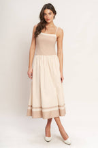 Color blocked midi dress with straight neckline, drop waist, full skirt, and smocked back