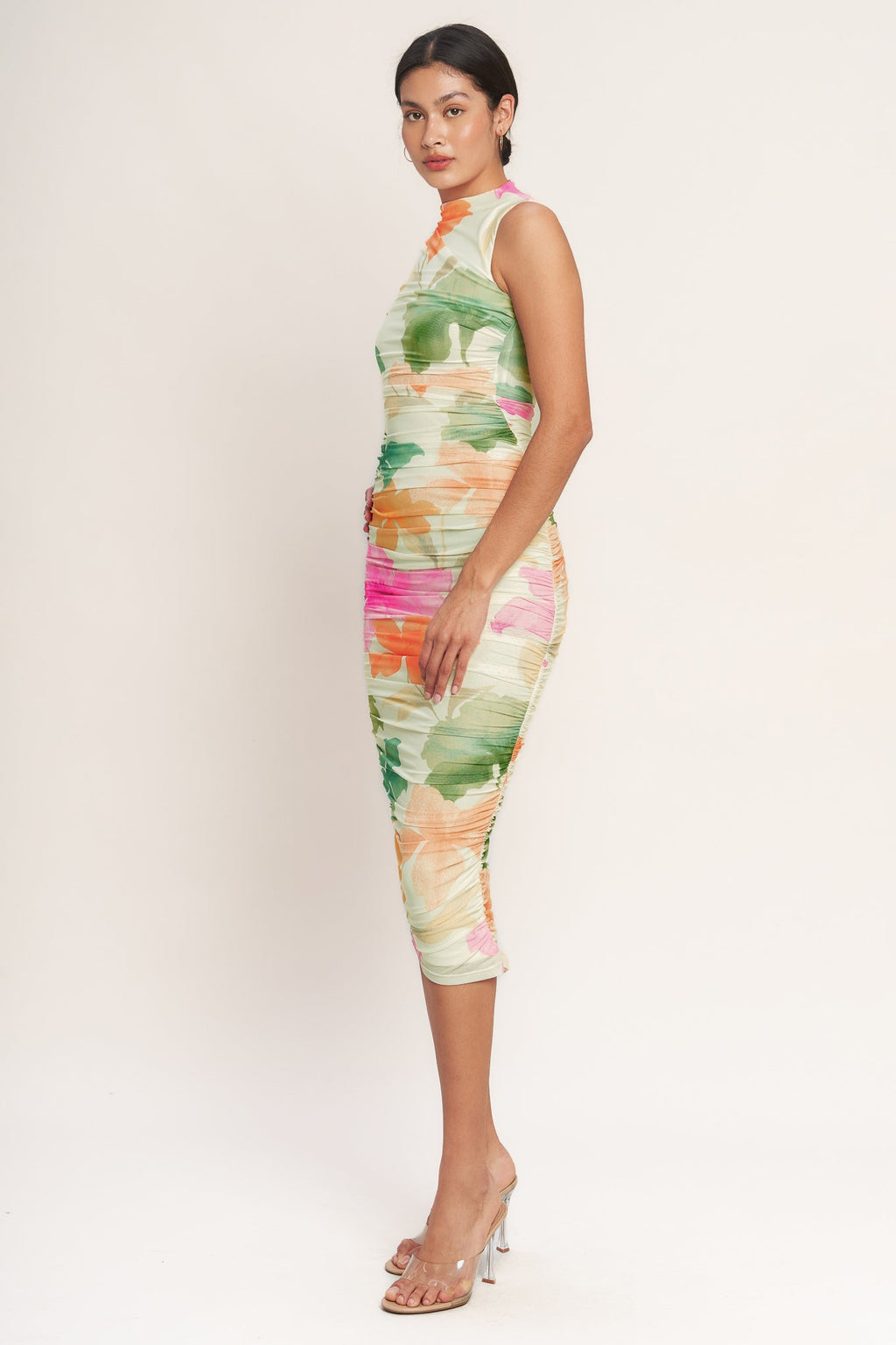 A colorful printed power mesh midi dress featuring tubular neckline, sleeveless, shirred side, body contouring and back zipper closure