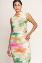 A colorful printed power mesh midi dress featuring tubular neckline, sleeveless, shirred side, body contouring and back zipper closure