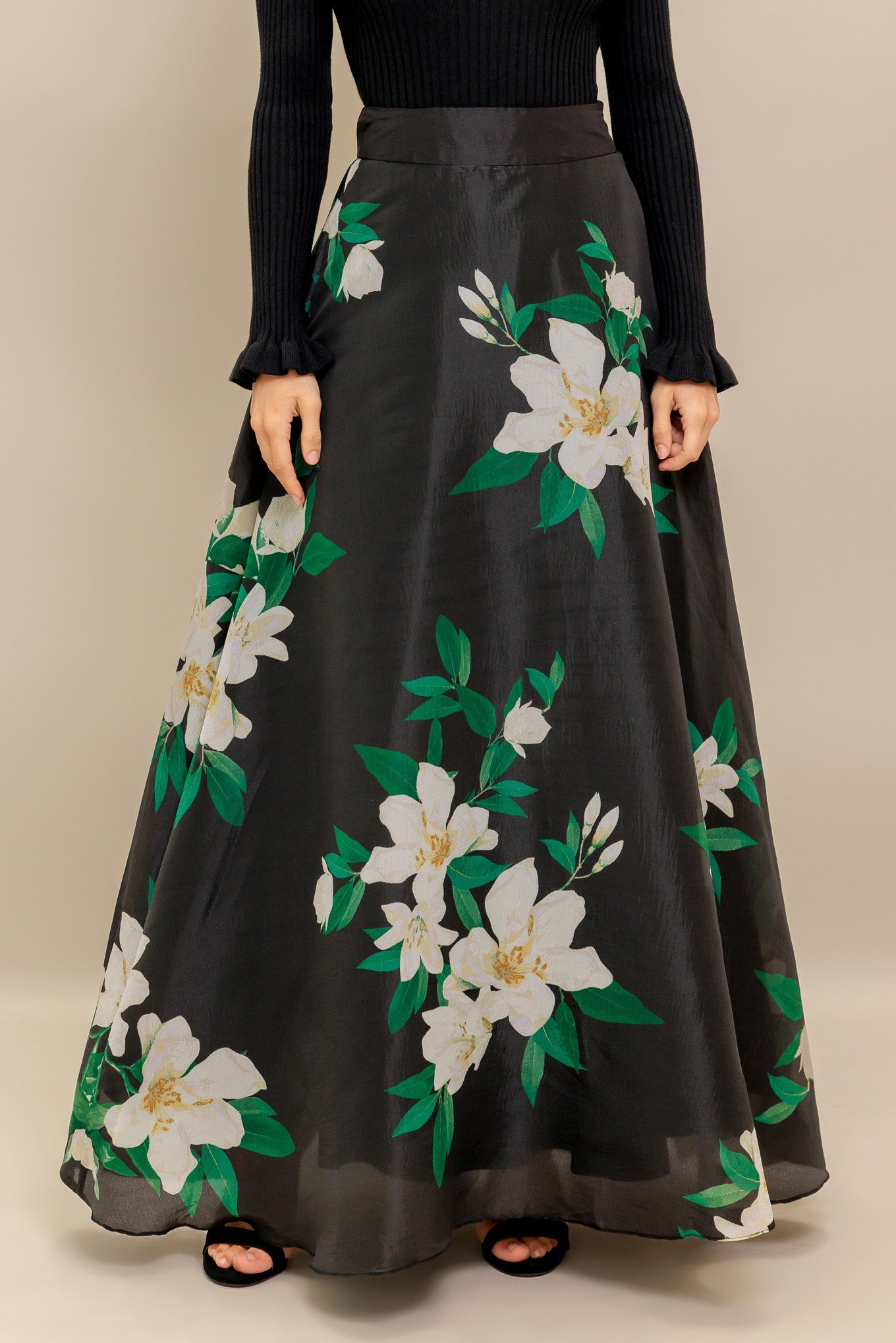 A black and white floral printed woven maxi skirt with side zipper closure