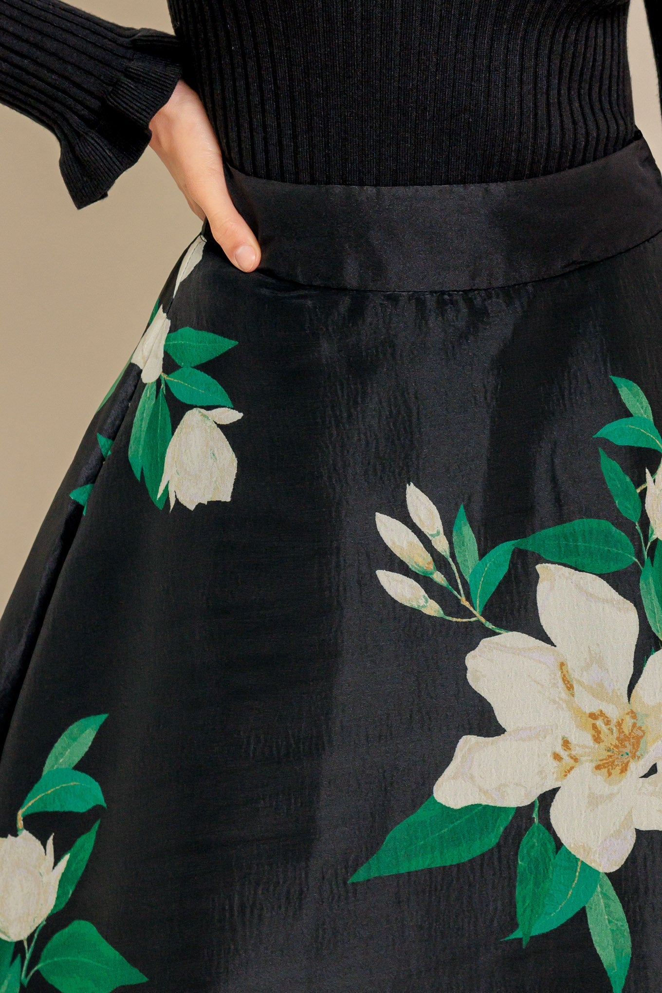 A black and white floral printed woven maxi skirt with side zipper closure