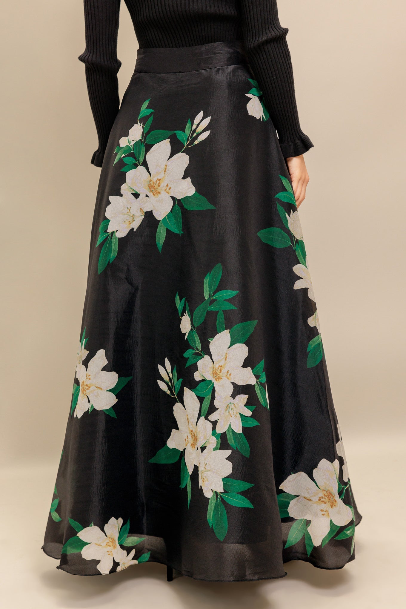 A black and white floral printed woven maxi skirt with side zipper closure
