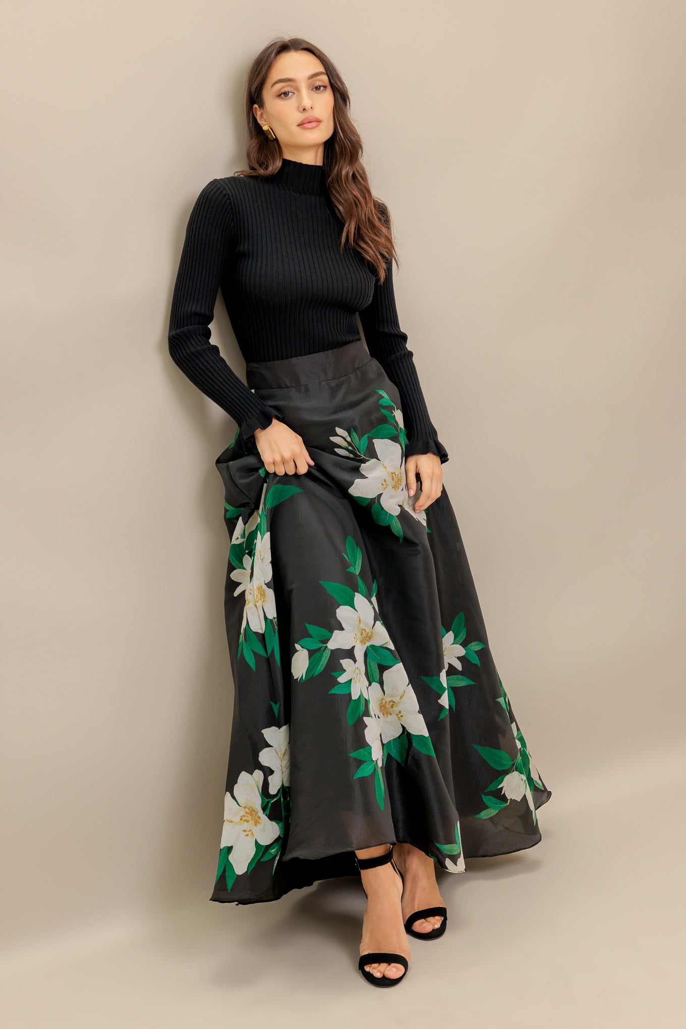 A black and white floral printed woven maxi skirt with side zipper closure