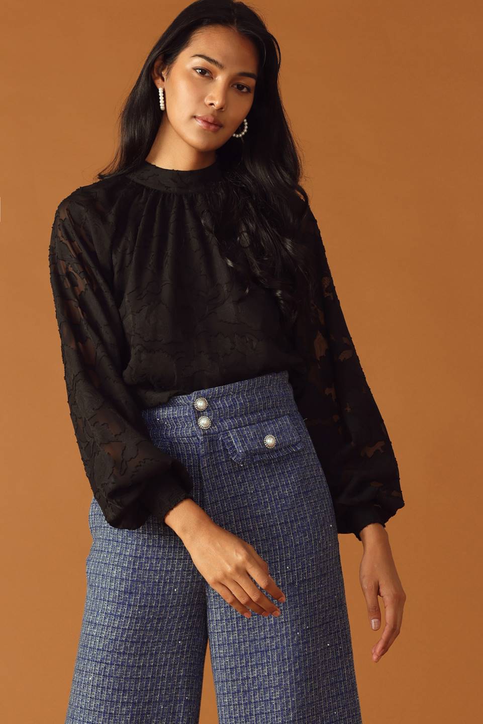 A tweed pant featuring front closure, jewel button and pockets