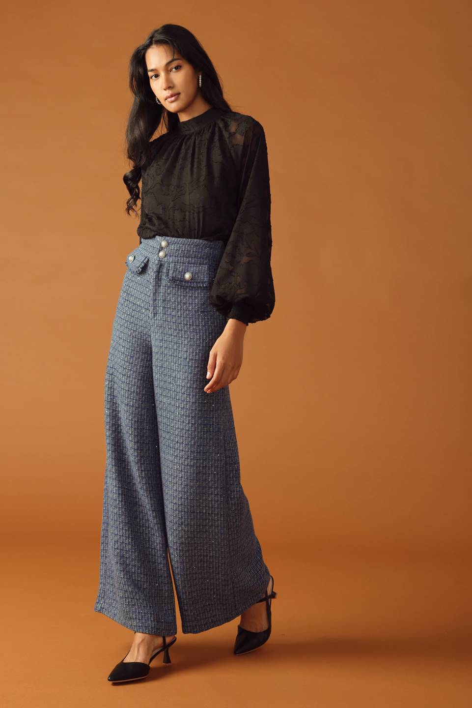 A tweed pant featuring front closure, jewel button and pockets