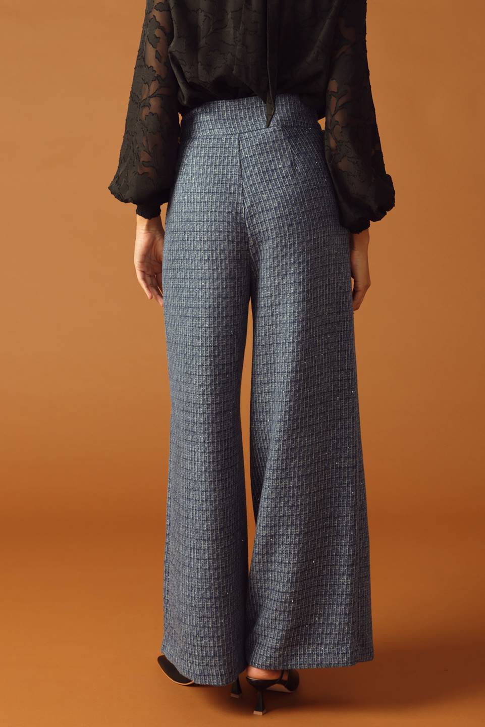 A tweed pant featuring front closure, jewel button and pockets
