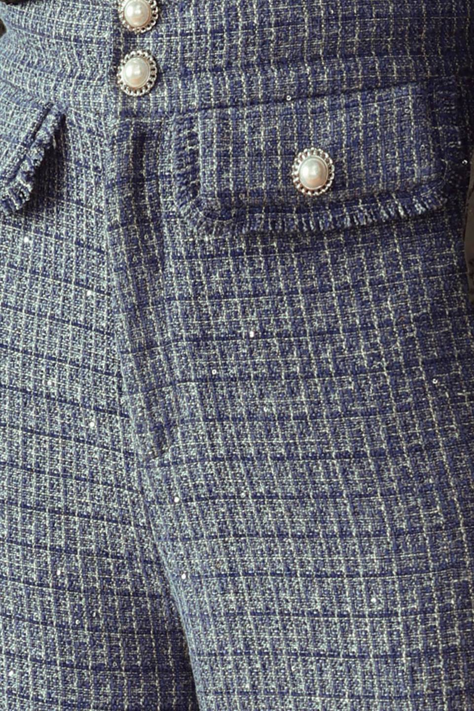A tweed pant featuring front closure, jewel button and pockets