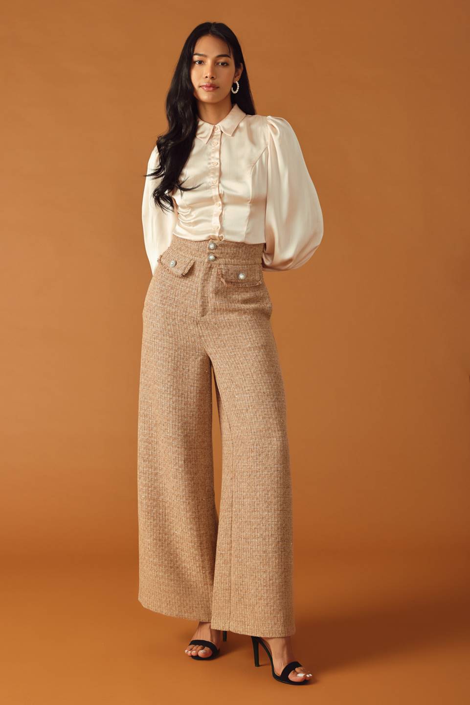 A tweed pant featuring front closure, jewel button and pockets