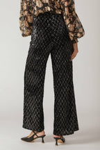 A black sequin pant featuring wide leg and side zipper closure.