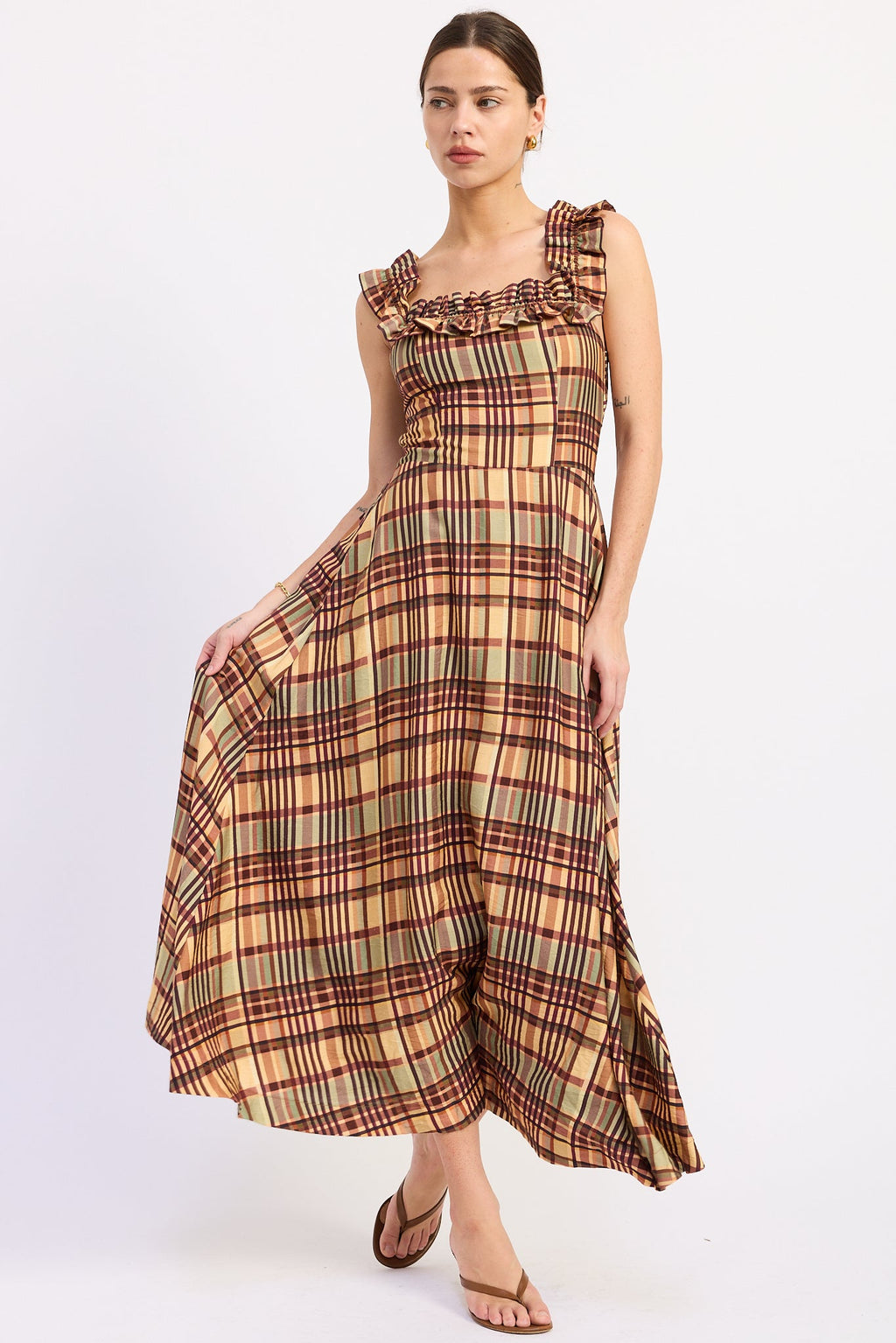 Model wearing the Kathleen almond plaid midi dress with a square neckline, ruffled straps, and a flared skirt.