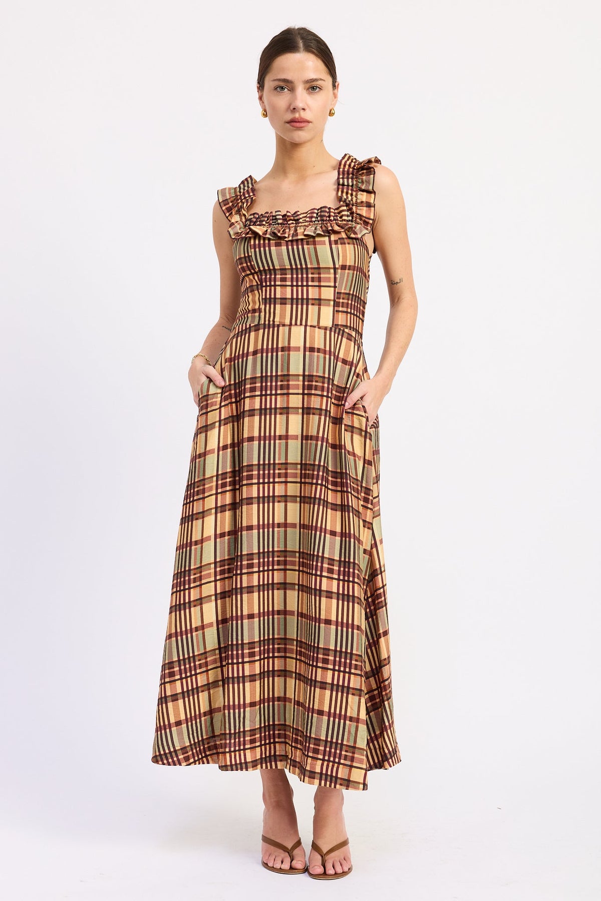 Model wearing the Kathleen almond plaid midi dress with a square neckline, ruffled straps, and a flared skirt.