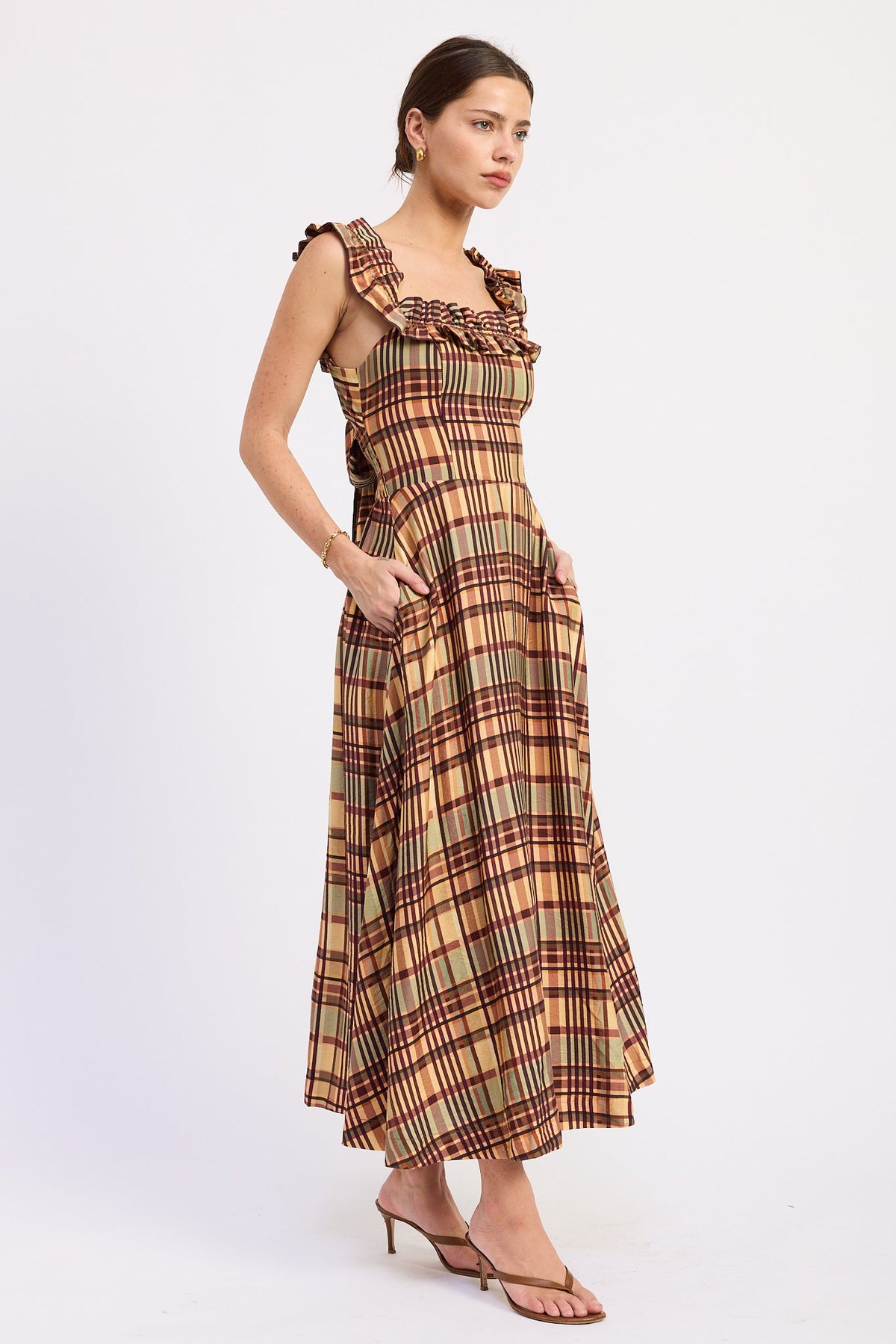 Model wearing the Kathleen almond plaid midi dress with a square neckline, ruffled straps, and a flared skirt.