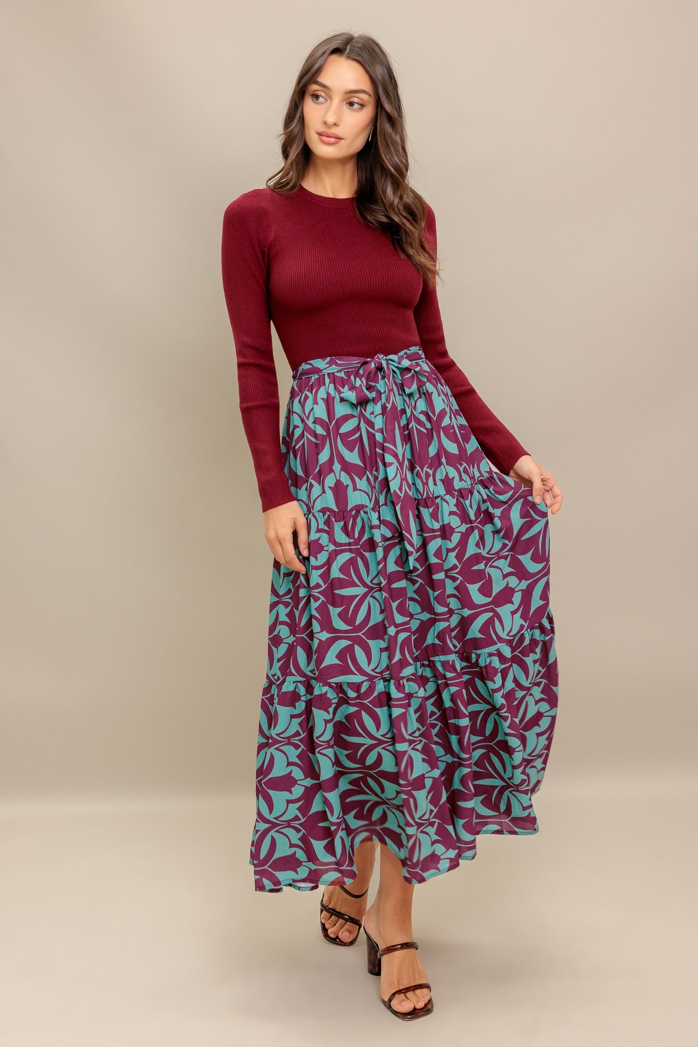 A sweater knit top and printed woven midi dress featuring round neckline, long sleeve and tiered skirt with sash tie