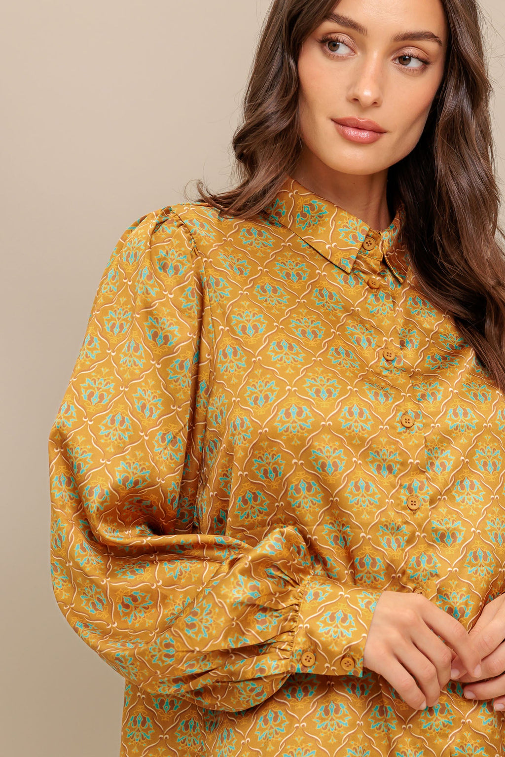 A printed woven top featuring collar, button down and long sleeve.