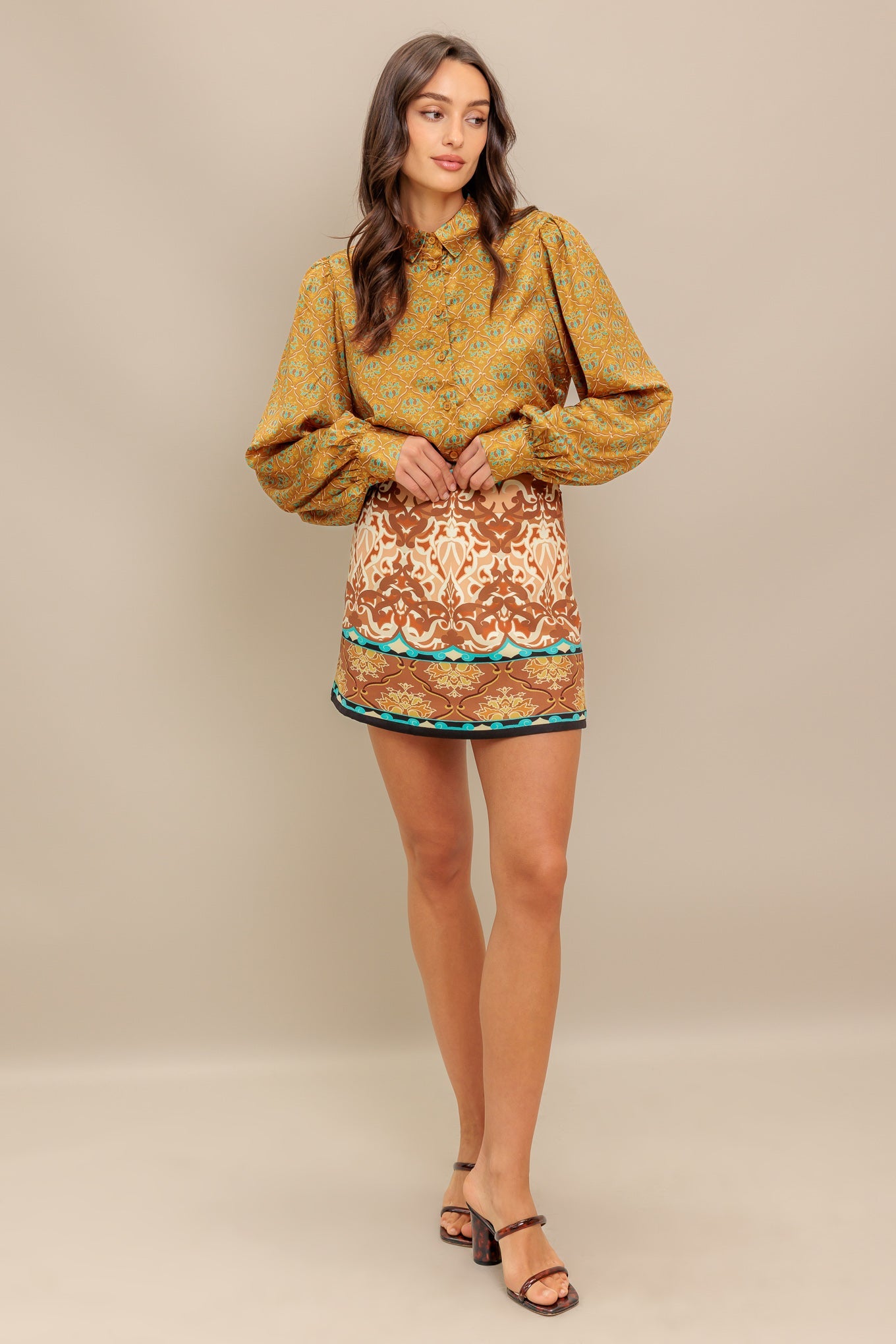 A printed woven top featuring collar, button down and long sleeve.