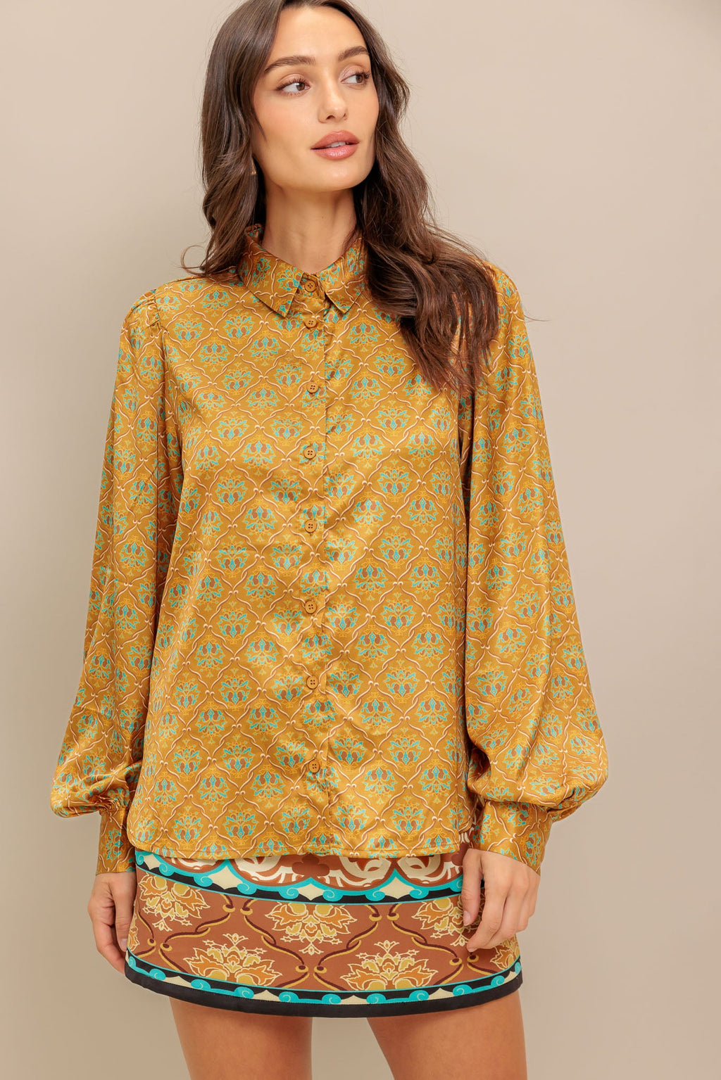 A printed woven top featuring collar, button down and long sleeve.