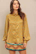 A printed woven top featuring collar, button down and long sleeve.