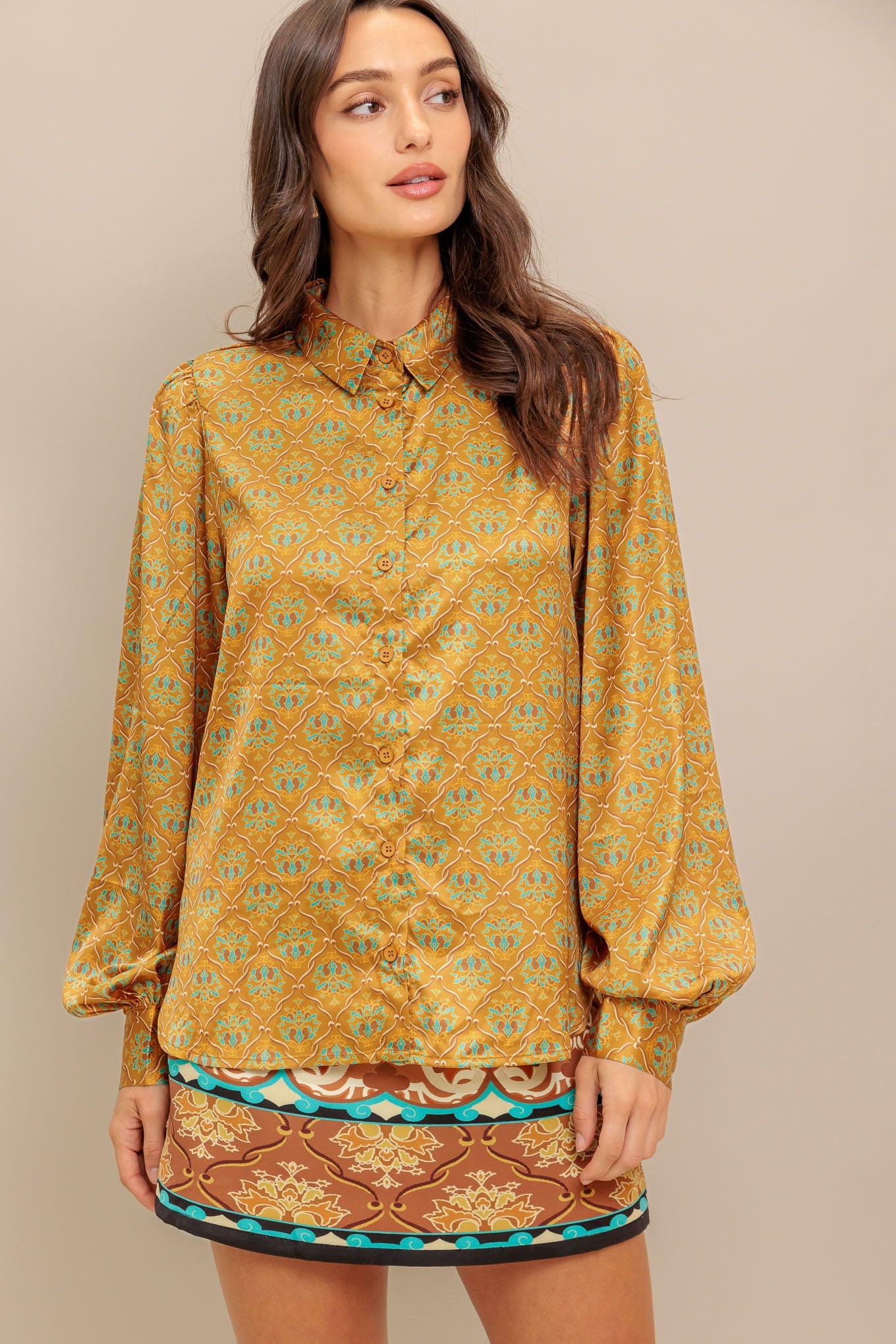 A printed woven top featuring collar, button down and long sleeve.