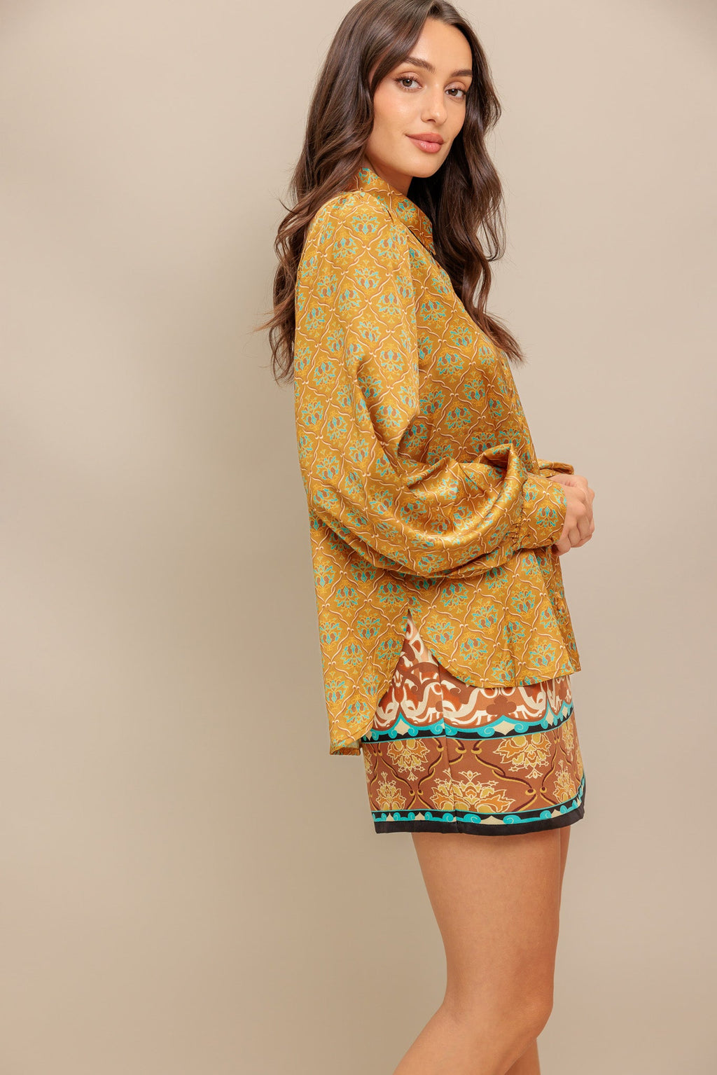 A printed woven top featuring collar, button down and long sleeve.