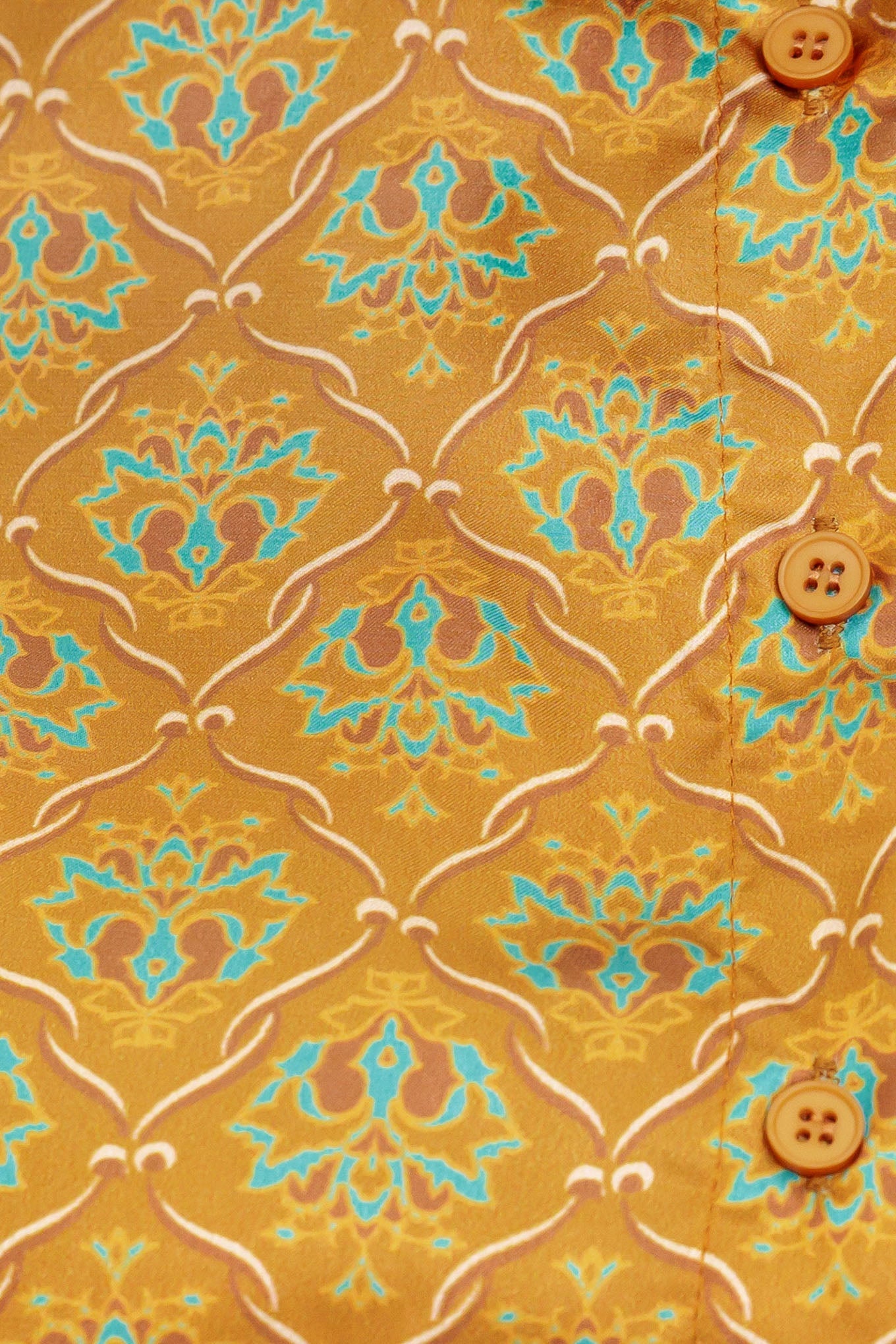 A printed woven top featuring collar, button down and long sleeve.