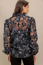 A woven organza top featuring high neckline with V center, long sleeve and cami