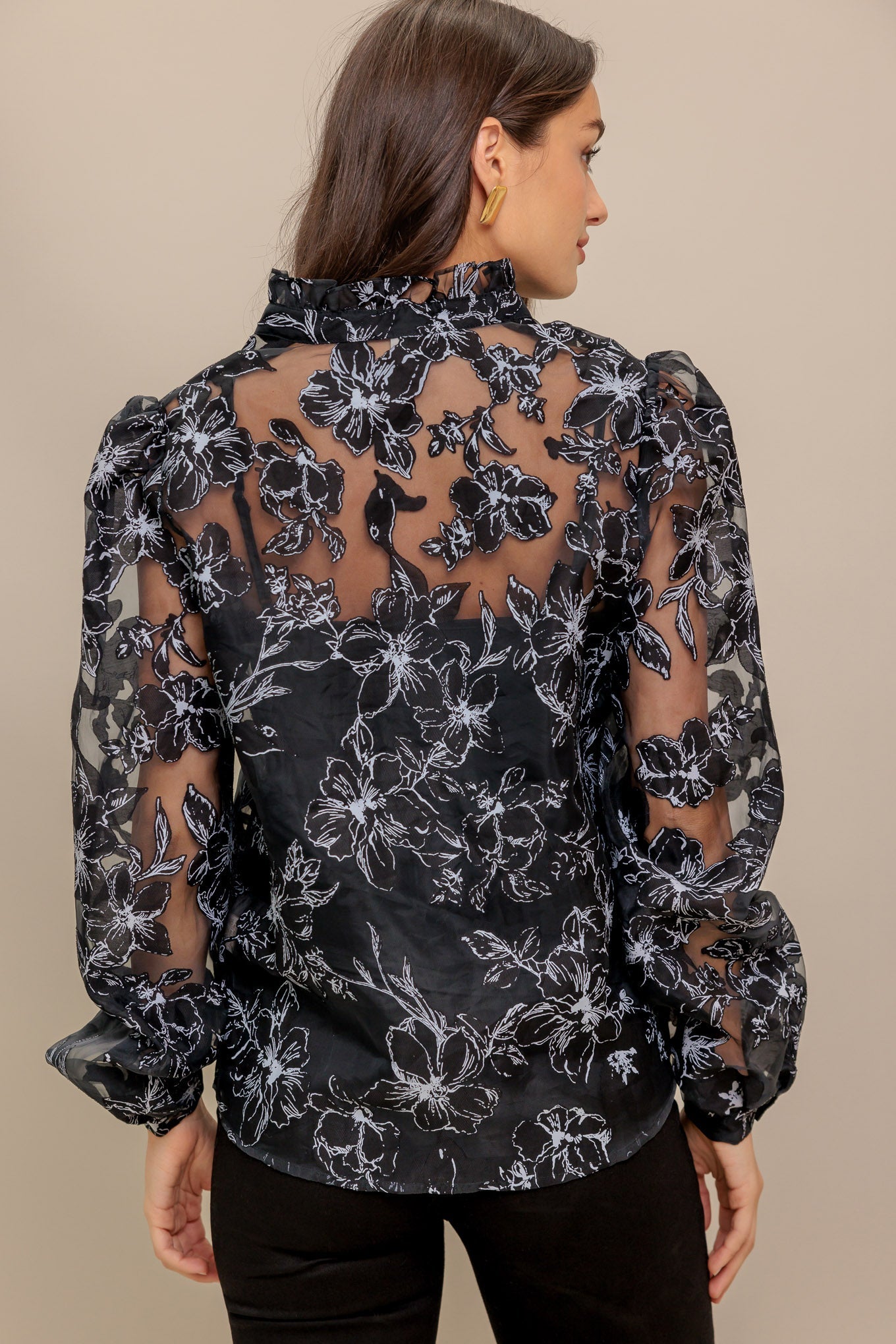 A woven organza top featuring high neckline with V center, long sleeve and cami