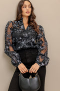 A woven organza top featuring high neckline with V center, long sleeve and cami