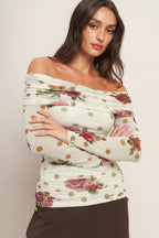 Woman wearing a floral off-shoulder top with polka dots