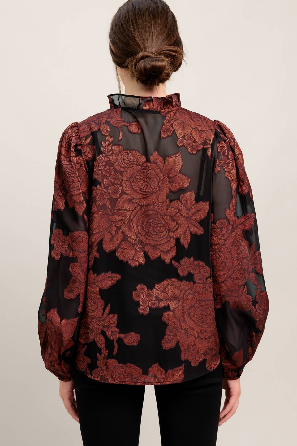 A jacquard woven top featuring ruffled neckline with front tie, button down and long sleeve
